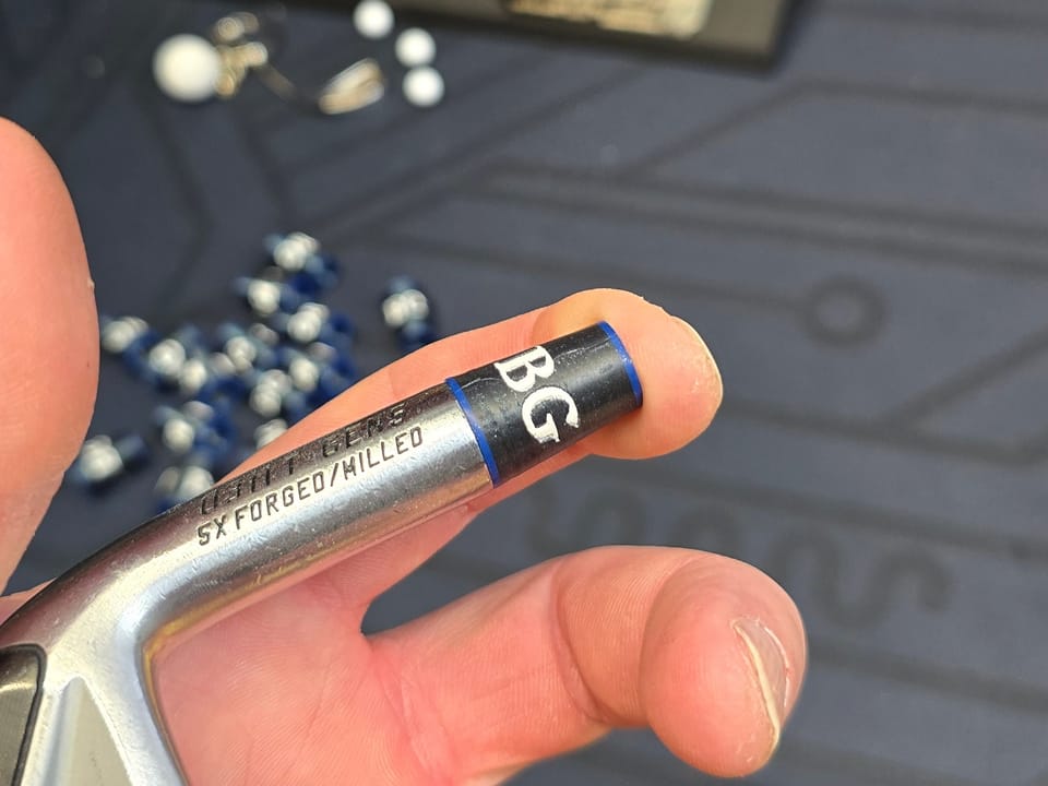 A custom ferrule printed with the initials BG and blue rings, installed on a PXG 0311 T GEN6 iron