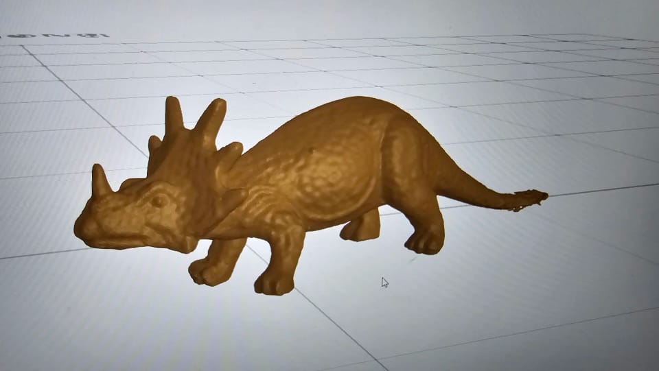A scanned dinosaur toy shown as a 3D model on screen