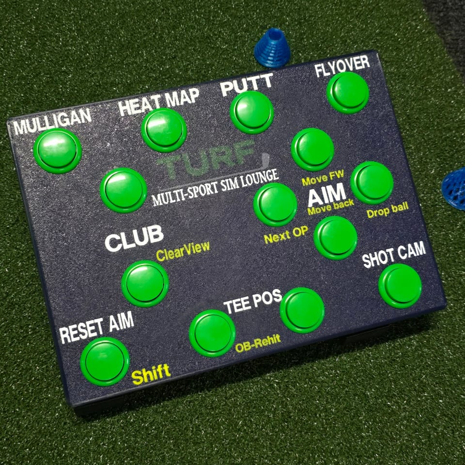 Custom control box built for TURF Multi-Sport Sim Lounge: navy box, green buttons, the TURF logo and yellow second-job labels