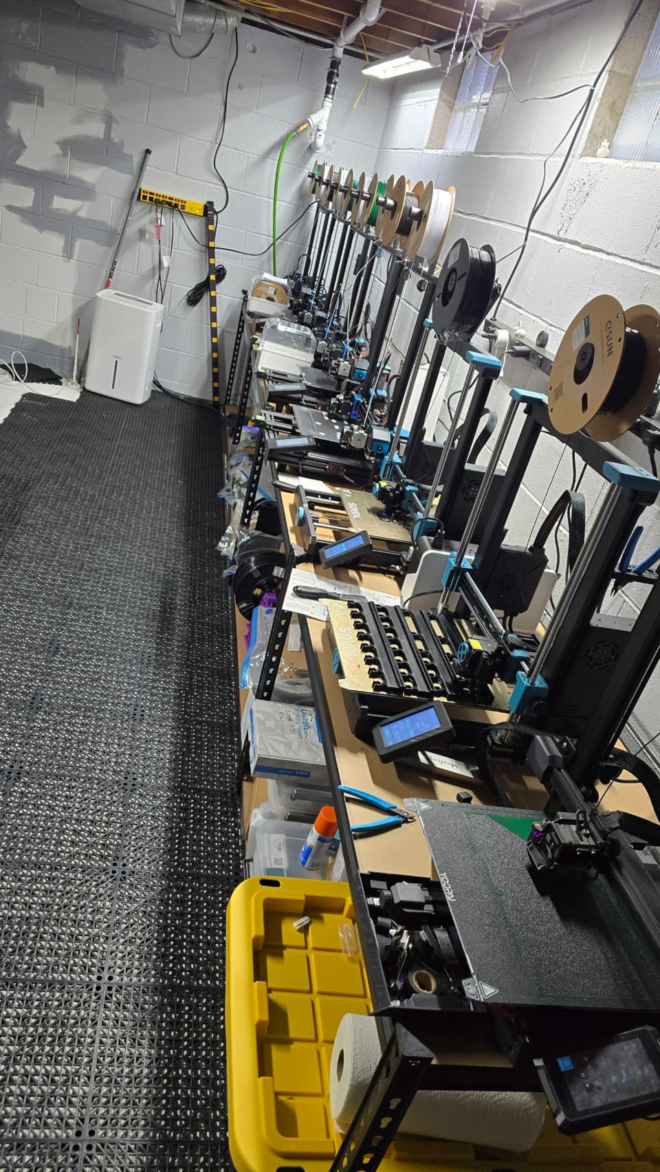 A row of 3D printers running at the shop
